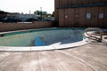 Empty concrete outdoor swimming poot at an abandoned hotel