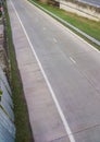 The empty concrete road to enter the expressway system with the metal fence