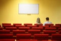 Empty conference hall. couple sitting in chairs Royalty Free Stock Photo