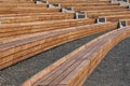 Empty contemporary wooden benches in open air outdoor city public event space.Modern urban public vandal proof resting furniture.