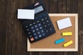 Empty cork board with wooden frame and calculator notepad sticky Royalty Free Stock Photo