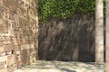 Empty corner of an ivy-covered decorative wall and old columns. Wall of stone blocks and bricks with pattern in ancient style.