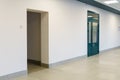 An empty corridor in an office building. Closed doors to the office and lobby. A spacious bright hall in the business center. Royalty Free Stock Photo