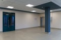 An empty corridor in an office building. Closed doors to the office and lobby. A spacious bright hall in the business center. Royalty Free Stock Photo