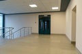 An empty corridor in an office building. Closed doors to the office and lobby. A spacious bright hall in the business center. Royalty Free Stock Photo