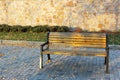 Empty country bench in the city during the day Wooden vintage bench in a public park. brown wooden empty park bench in Royalty Free Stock Photo