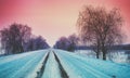 Empty country road covered with snow in winter Royalty Free Stock Photo