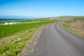 Empty country road in Ic eland under blue sky in summer