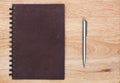 cover notebook with pen is on wood background