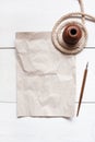 Empty crumple sheet of paper, inkpot, pen and rope Royalty Free Stock Photo