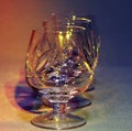 Empty crystal glasses in colored light toning