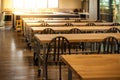 Empty culinary school classroom with rows of tables and chairs