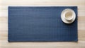 Empty cup on a blue placemat on a wood surface. Generative AI Royalty Free Stock Photo