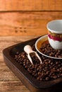 Empty cup and coffee beans in wooden tray Royalty Free Stock Photo