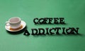 Almost empty cup of coffee with text COFFEE ADDICTION on color background Royalty Free Stock Photo