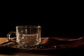 Empty cup and group of coffee beans on brown table cloth with black background with copy space for your text. Benefits of coffee Royalty Free Stock Photo