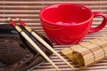 Empty cup and sushi chopsticks on a empty plate Royalty Free Stock Photo