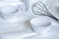 Empty cupcake mold White Paper baking cups for cupcakes and muffin bakeware on white fabric in the kitchen