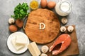 Empty cutting board and frame of varied food rich in vitamin D. Healthy eating concept. Top view, flat lay