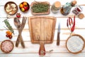 empty cutting board, ingredients and spices on a white kitchen table. View from above. Space for text and menu Royalty Free Stock Photo
