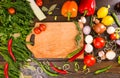 Empty cutting board surrounded by vegetables Royalty Free Stock Photo