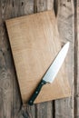 Empty cutting board on a wooden background. Top view. Space for text.Flat lay. Cooking food background Royalty Free Stock Photo