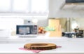 Empty cutting board on a wooden table and blurred kitchen background Royalty Free Stock Photo