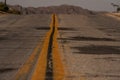 Empty, damaged surface road in the middle of nowhere