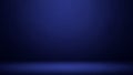 Empty dark blue studio background with subtle spotlight effect and soft floor shadow creating a dramatic presentation Royalty Free Stock Photo