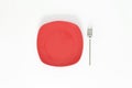 Empty Dark Blush Red color plate and fork next to it. Isolated object - on white background