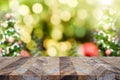 Empty dark brown wood table top with abstract blur christmas tree red decor ball and snow fall background with Royalty Free Stock Photo