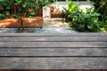 Empty dark hardwood table top on blurred garden background