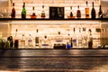 Empty dark wooden bar counter with blur background bottles of re Royalty Free Stock Photo