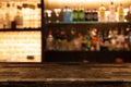 Empty dark wooden bar counter with blur background bottles of re Royalty Free Stock Photo