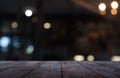 Empty dark wooden table in front of abstract blurred background of cafe and coffee shop interior. can be used for display or Royalty Free Stock Photo