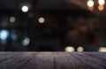 Empty dark wooden table in front of abstract blurred background of restaurant, cafe and coffee shop interior. can be used for Royalty Free Stock Photo