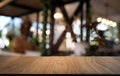 Empty dark wooden table in front of abstract blurred bokeh background of restaurant . can be used for display or montage your Royalty Free Stock Photo