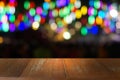 Empty dark wooden table in front of abstract blurred bokeh background of restaurant.