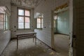 Empty decaying room with a table and torn ceramic walls in an abandoned place