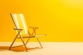 Empty deck chair on yellow background. Sunbed, studio shot. Beach tourism, travel, relax, vacai, holiday background. Minimal