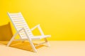 Empty deck chair on yellow background. Sunbed, studio shot. Beach tourism, travel, relax, vacai, holiday background. Minimal