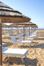 Empty deck chairs on coastal beach Royalty Free Stock Photo
