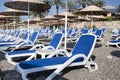 Empty deckchairs and umbrellas with a thatched roof on the beach