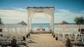 Empty Decorated Outdoors Wedding Venue with Chairs for Official Ceremony on a Beach Near the Sea or