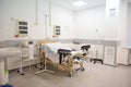 Empty delivery room with bed and medical equipment in maternity ward at hospital. Childbirth. Delivery. Labor concept Royalty Free Stock Photo