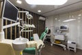 Empty dentist office with chair and various dental equipment