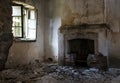 Empty deserted house room with fireplace. Abandoned collapsing places