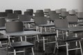 Empty desk seats in lecture room or school classroom