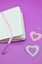 empty diary on purple background with hearts Royalty Free Stock Photo