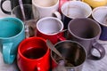 Empty dirty coffee cups of different colors on the table. Concept of caffeine dope, lack of energy and long wait. Copy space Royalty Free Stock Photo